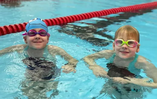 a couple of kids in a pool