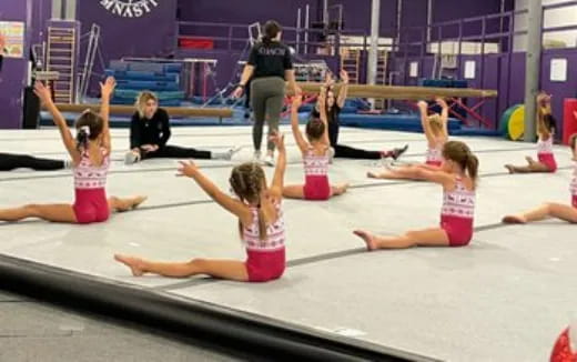 a group of girls doing yoga