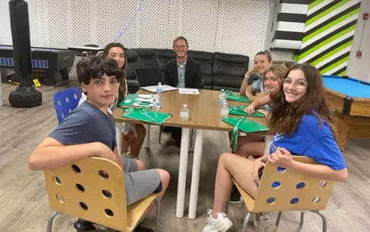 a group of people sitting around a table