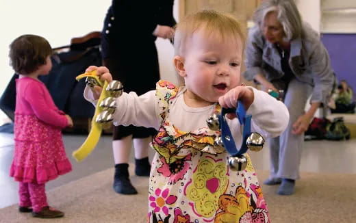 a baby holding a toy