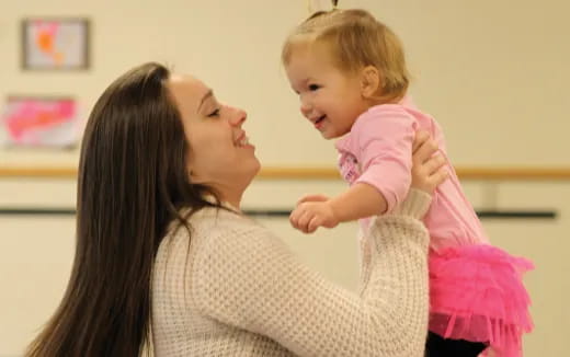 a woman holding a baby