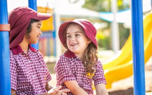 a couple of children in pink hats