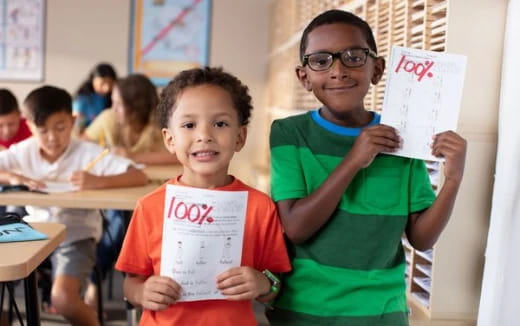 a couple of boys holding signs