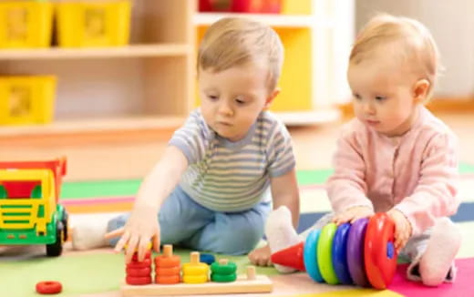 two babies playing with toys