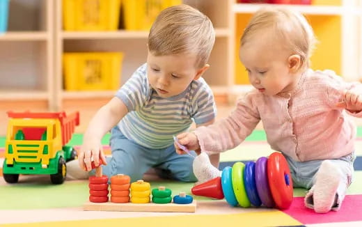 two babies playing with toys