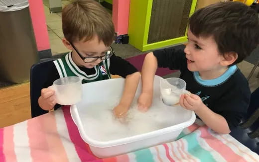 two boys playing with cups