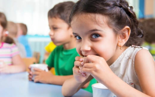 a young girl eating food