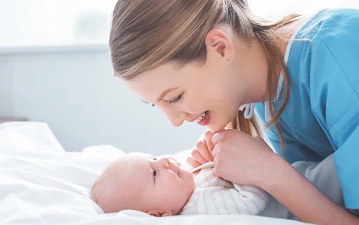 a woman holding a baby