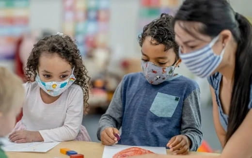 a group of children sitting at a table