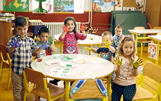 a group of children sitting around a table