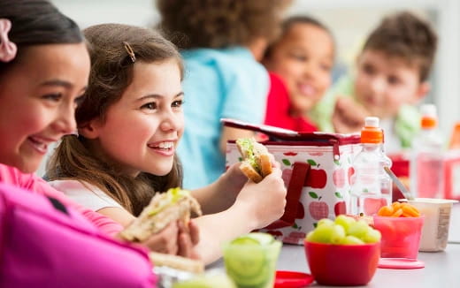 a group of kids eating food