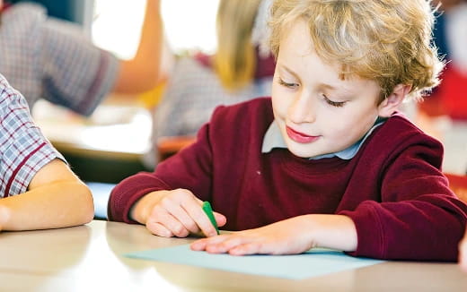a child writing on a paper