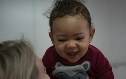 a baby holding a toy