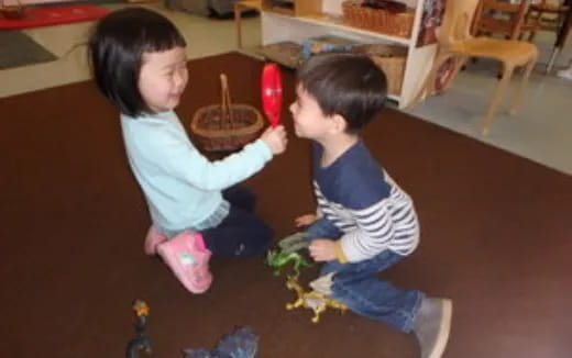 a couple of kids playing with toys