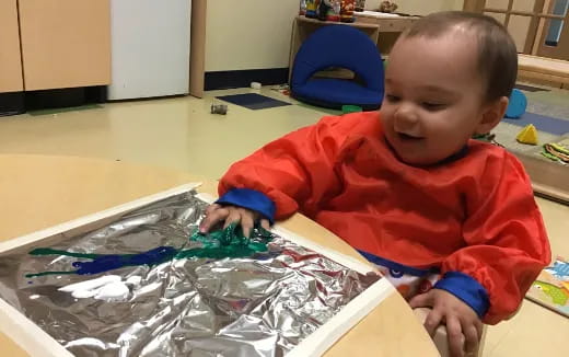 a baby playing with plastic