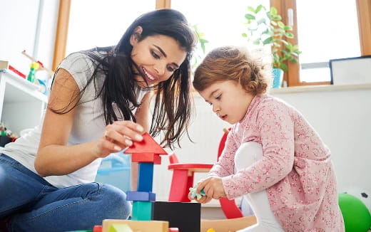 a person and a child playing with toys