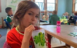 a girl eating a pineapple