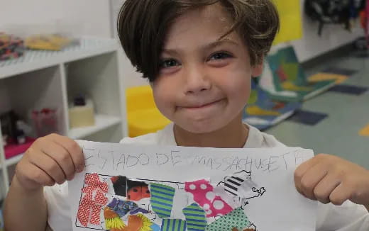 a child holding a drawing