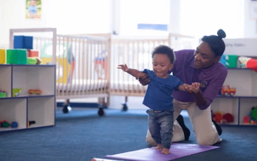 a person and a child in a room with a baby