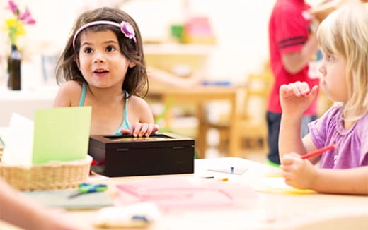 a few children sitting at a table