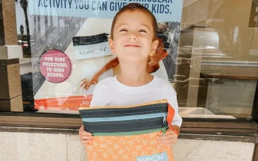 a child holding a box