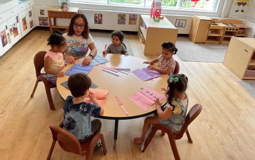 a group of children sitting around a table