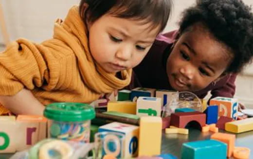 a couple of girls playing with toys