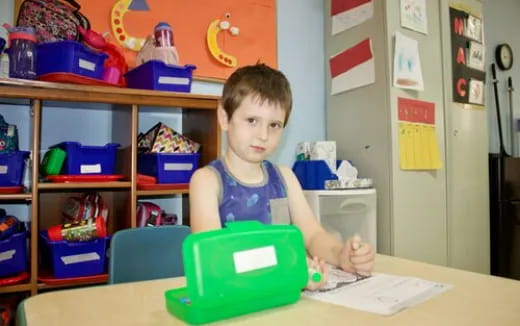 a boy sitting at a desk