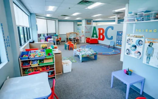 a room with a few children's toys and a few tables