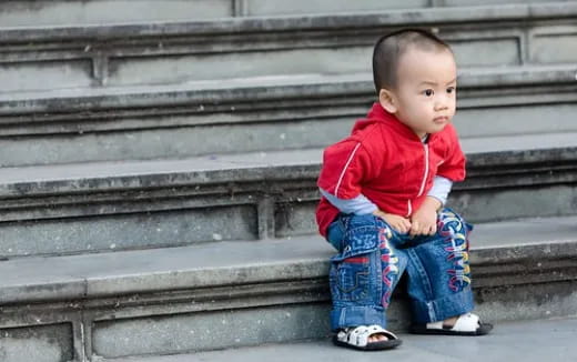 a baby sitting on steps