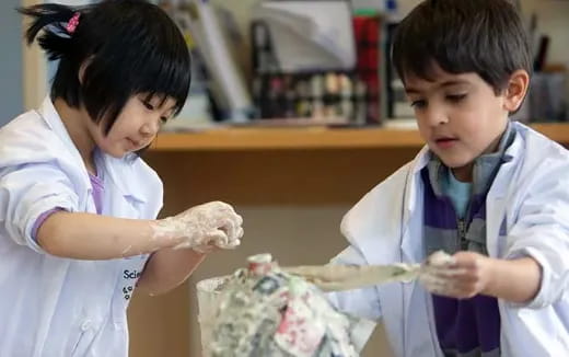 medium shot of kids wearing lab coats