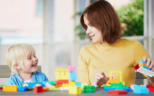 a person and a child playing with toys