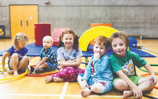 a group of children sitting on mats