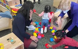 a group of people playing with toys
