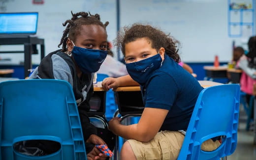 a young boy and girl in a classroom