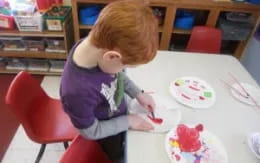 a child painting on a table