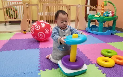 a baby sitting on a toy