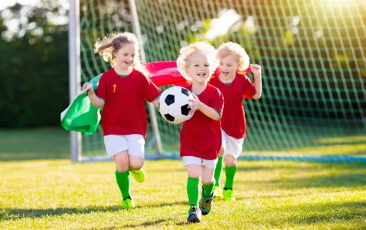 a group of kids playing football