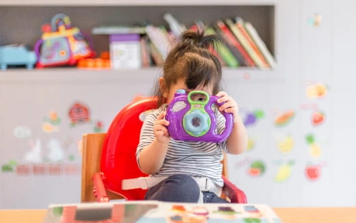 a girl holding a toy