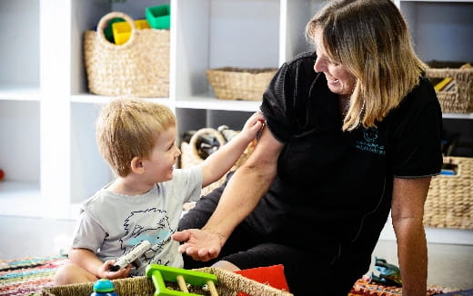 a person and a child playing with a toy
