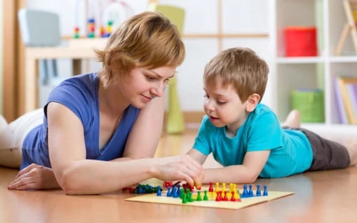 a person and a boy playing with a toy