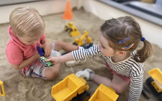 a couple of children playing with toys
