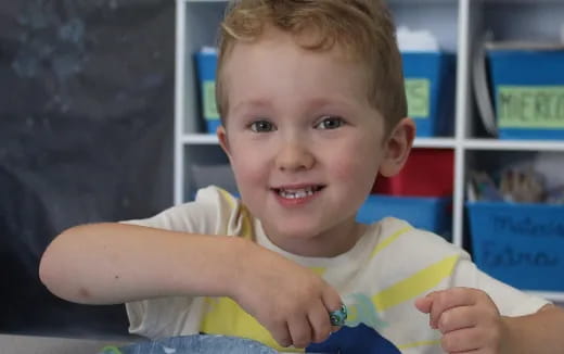 a baby holding a yellow object