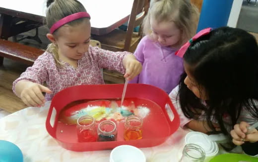 a group of children painting
