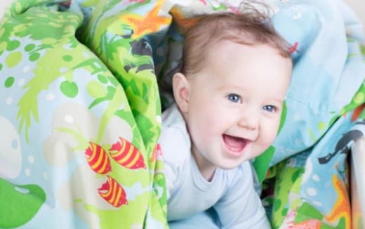a baby lying on a blanket