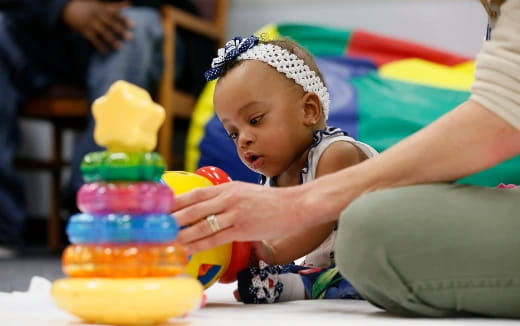 a baby playing with toys