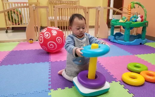 a baby playing with toys