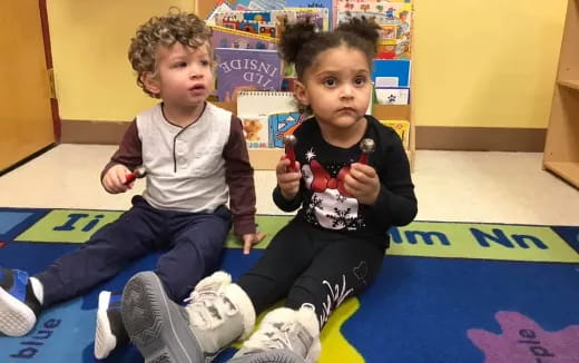 a couple of children sitting on the floor