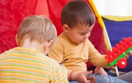 a couple of boys playing with toys