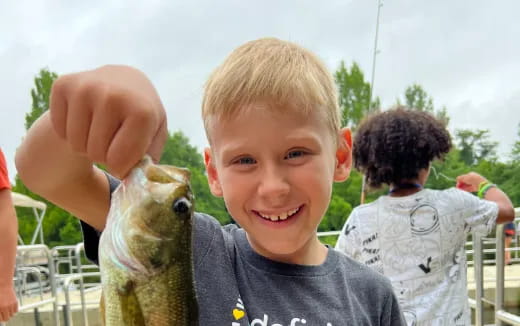 a boy holding a lizard